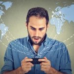 A young man doing an international trademark search for filing an international trademark registration