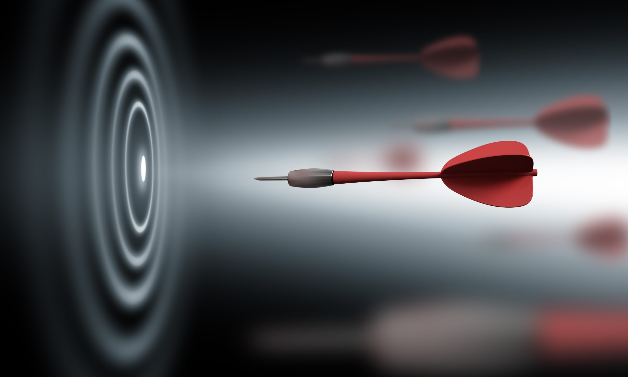 Red dart flying precisely towards the bullseye target, symbolizing accuracy, focus, and goal achievement.