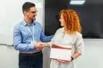 Woman receiving certificate for graduating from trademark certification program